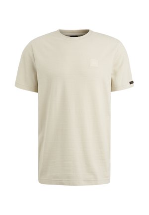 Kortærmet creme t-shirt lavet af tekstureret stof, med en lille firkantet lap på brystet og et kontrasterende sideskilt.