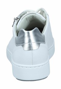 White sneaker with textured leather material, silver metallic accent on the heel, and a rounded toe. Features a zip closure and flat sole.