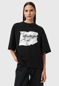 T-shirt nera oversize con una grafica bianca stropicciata sul davanti con il testo "ALL SAINTS" e caratteri giapponesi. Maniche corte.