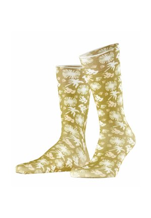 Jasno oliwkowe skarpetki do kostki z białymi tropikalnymi liśćmi i kwiatowymi wzorami ułożonymi obok siebie.