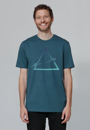 Teal cotton t-shirt featuring a large geometric triangle design in gradient colors, short sleeves, and a round neckline.