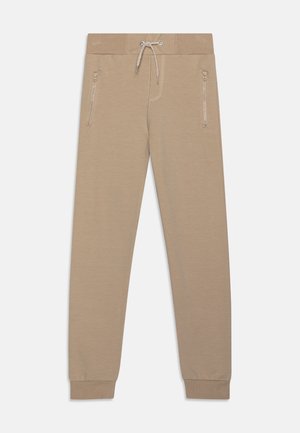 Beige Sweatpants aus weichem Stoff, mit einem Kordelzugbund, seitlichen Reißverschlüssen und eng anliegenden Bündchen. Minimalistisches Design ohne Muster.