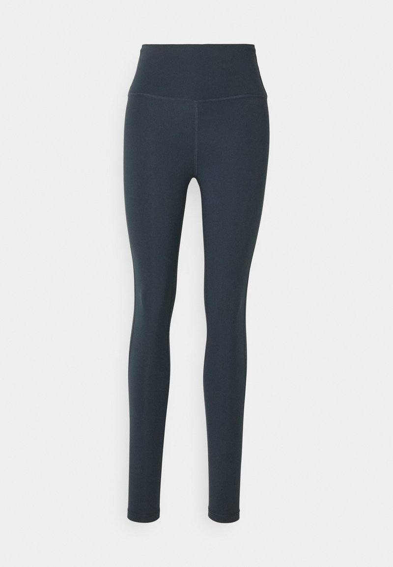 Leggings taille haute en bleu marine foncé, fabriqués en tissu léger et extensible avec une texture lisse et sans motifs ni accessoires visibles.