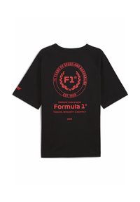 Musta lyhythihainen t-paita, jossa on näkyvä punainen pyöreä logo, jossa lukee "F1" ja teksti 75-vuotisjuhlasta. Pehmeä kangas.