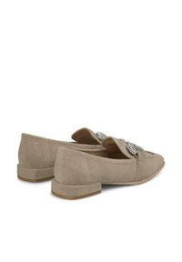 Beige suède instappers met een puntige neus en kleine blokhak, voorzien van een decoratieve strassversiering over de bovenkant.