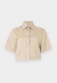 Cropped beige shirt with short sleeves, button front, and silver buttons. Features a yellow embroidered detail on the left side.