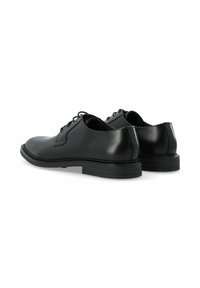 Chaussures habillées en cuir noir avec une surface lisse, un bout arrondi et un design élégant. Elles disposent de lacets et d'une semelle en caoutchouc plate et basse.