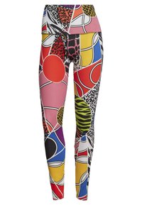 Leggings multicolores avec des motifs abstraits incluant des cercles et des motifs animaliers, confectionnés en matériau extensible et ajusté.