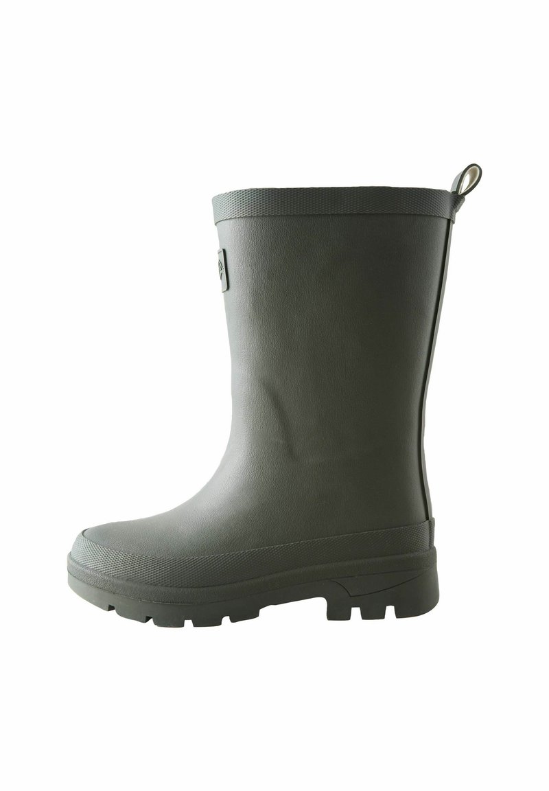 Harmaa kumisaapas, jossa on teksturoitu pinta, pyöristetty kärki ja paksu, kestävä pohja, joka tarjoaa pitoa. Mukana vetotappi takana.