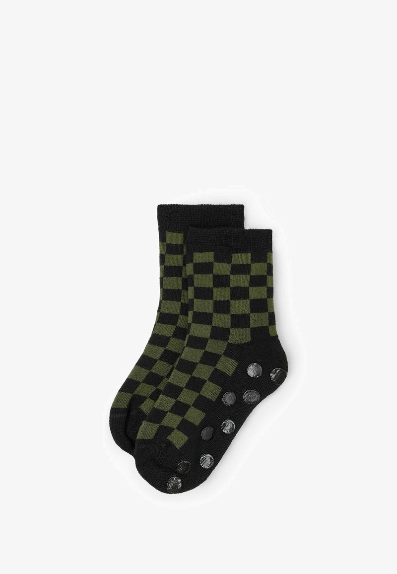 Calzini a scacchi neri e verde oliva con una trama a maglia e punti antiscivolo sulla suola per una maggiore trazione e stabilità.