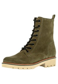 Olive suede ankle boot with black laces, round toe, and stitched detailing. Chunky beige sole with a textured pattern for traction.