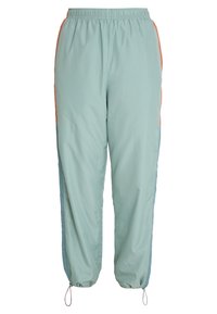 Ljust blå joggerbyxor i en mjuk tyg, med elastisk midja, sidodetaljer i orange och blått samt avsmalnande mudd.