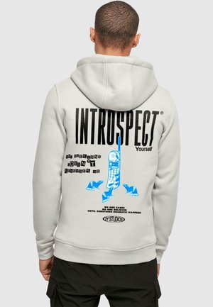 Light gray hoodie with a large blue print featuring a retro phone and text. Features kangaroo pockets and ribbed cuffs and hem.