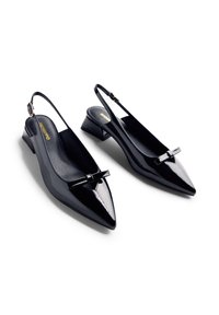 Black patent leather slingback shoes with a pointed toe, small block heel, and a decorative bow at the front. Smooth texture and sleek design.