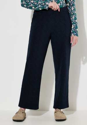 Marineblauwe hoge taille wijde broek met een subtiel bladvormig patroon, gemaakt van textuurstof, gecombineerd met een patroon met lange mouwen top.