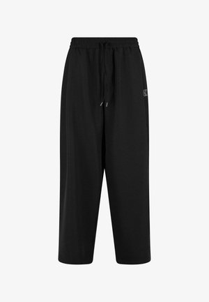 Sorte sweatpants med elastisk talje og snøre. Fremstillet af blødt stof, med en afslappet pasform og sidelommer.