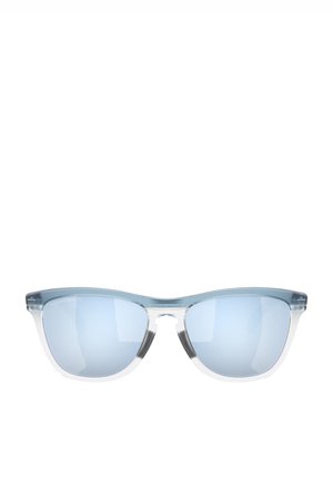 Occhiali da sole tinti di blu con montatura trasparente, forma a occhio di gatto e lenti specchiate. Hardware minimo e superficie liscia.