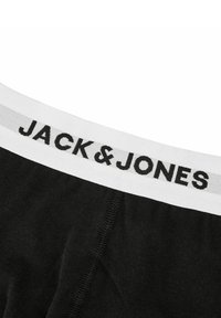 Boxer briefs neri in cotone con una cintura elastica bianca che presenta la scritta "JACK & JONES" in nero. Texture liscia e design aderente.