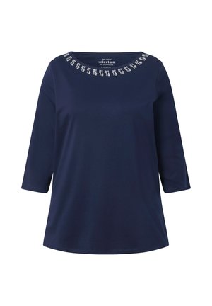 Navy blue, 3/4 sleeve top made of smooth fabric, featuring a rounded neckline with metallic embellishments along the collar.