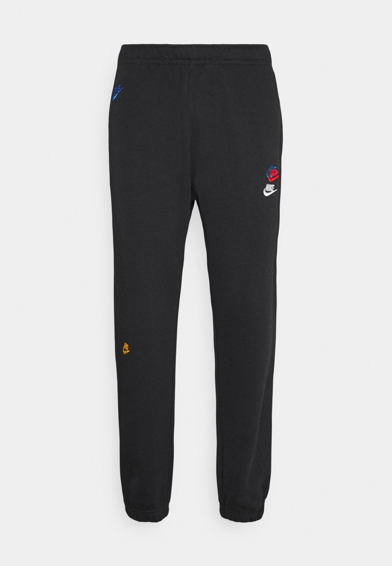 Černé nike tepláky s elastickým pasem a manžetami, zdobené barevnými logy Nike na levém stehně, pravé kapse a dolní části levé nohy.