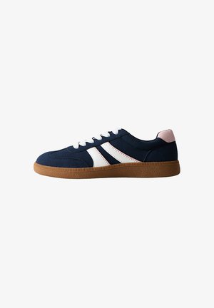 Navy blue sneaker with white stripes, pink heel tab, white laces, and brown rubber sole, shown in side profile on white background.