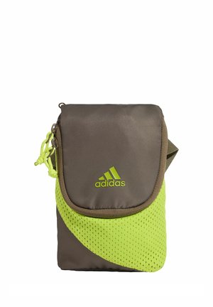 Small Adidas crossbody bag with brown fabric, neon green mesh detail, flap closure, and logo on front.