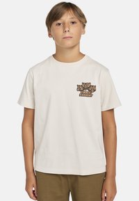 Lycra-lyhyt hihainen kerma-valkoinen t-paita, joka on valmistettu puuvillasta. T-paidassa on painettu karhun grafiikka ja "Timber Element" -teksti vasemmassa rintataskussa.