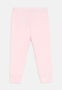 Ljust rosa leggings i ribbat tyg med elastisk midja och åtsittande mudd vid anklarna. Slät textur utan synliga mönster.