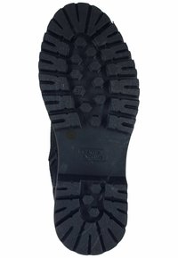 Black rubber shoe sole featuring deep tread grooves, hexagonal patterns, and a logo reading "camel active," with a size mark of 37.