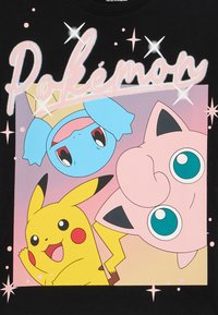 Black T-shirt featuring cartoon characters: Pikachu, Squirtle, and Jigglypuff against a pastel background with stars and "Pokémon" text.