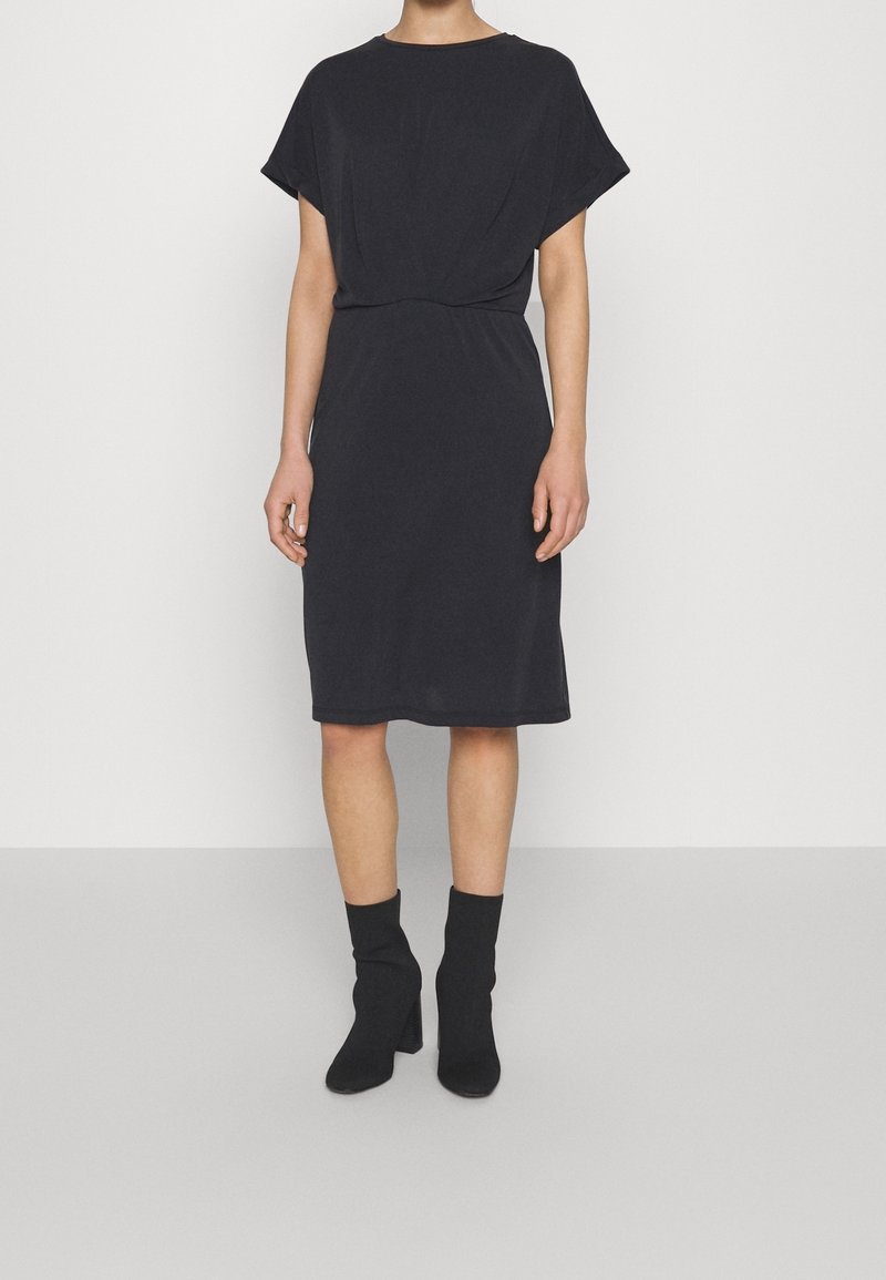 Schwarzes knielanges Kleid mit kurzen Ärmeln, einem lockeren Schnitt und einer gerafften Taille. Verfügt über einen weichen Stoff und einen einfachen runden Ausschnitt.