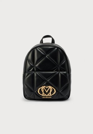 Black quilted backpack made of faux leather, featuring a gold-tone logo accent and a rounded top. Zipper closure and top handle design.