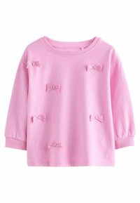 Rosa sweatshirt med lange ærmer, rund halsudskæring og små stofsløjfer i forskellige positioner. Blød tekstur og ribbede manchetter.