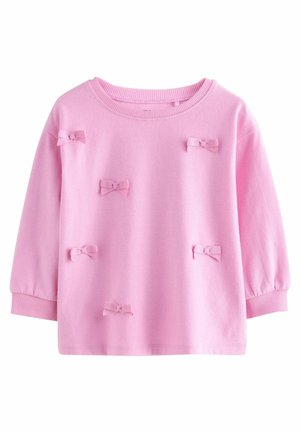 Różowy sweter z długimi rękawami, okrągłym dekoltem i małymi kokardkami z materiału w różnych miejscach. Miękka tekstura i ściągacze przy mankietach.