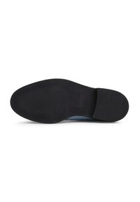 Schwarze Gummisohle mit strukturierter Oberfläche. Rundliche Form und leicht erhöhter Absatz, mit einem glatten blauen Akzent am Rand.