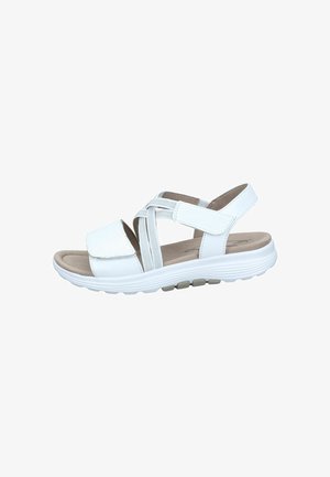 White sandal with multiple cross straps and adjustable closure. Soft footbed with a textured sole and cushioning. Lightweight and flexible design.
