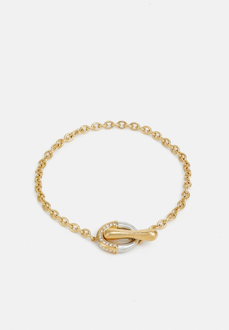 Goldene Kettenarmband mit einem Toggle-Verschluss, verziert mit einem silbernen Akzent und klaren Strasssteinen für Details. Runde Glieder durchgehend.