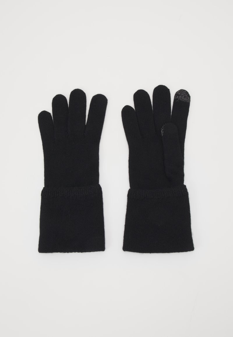 Gants en tricot noirs avec ouvertures pour les doigts, manches longues, texture à côtes et un bout de doigt compatible avec les écrans tactiles sur un des gants.