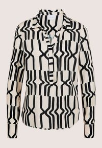 Langärmlige Bluse in Creme mit mutigem schwarzen abstraktem Muster. Verfügt über einen Kragen und eine geknöpfte Leiste, gefertigt aus glattem Stoff.