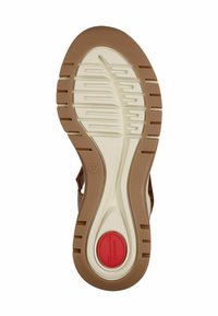 Braune Gummisohle mit strukturiertem Grip-Muster, weiße Zwischensohle und rotes Komfortlabel. Größe 37 auf der Seite angegeben.