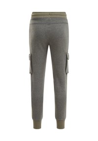 Grå sweatpants med en texturerad tyg, elastisk midja och ribbade muddar. Har två sidofickor för extra funktionalitet.