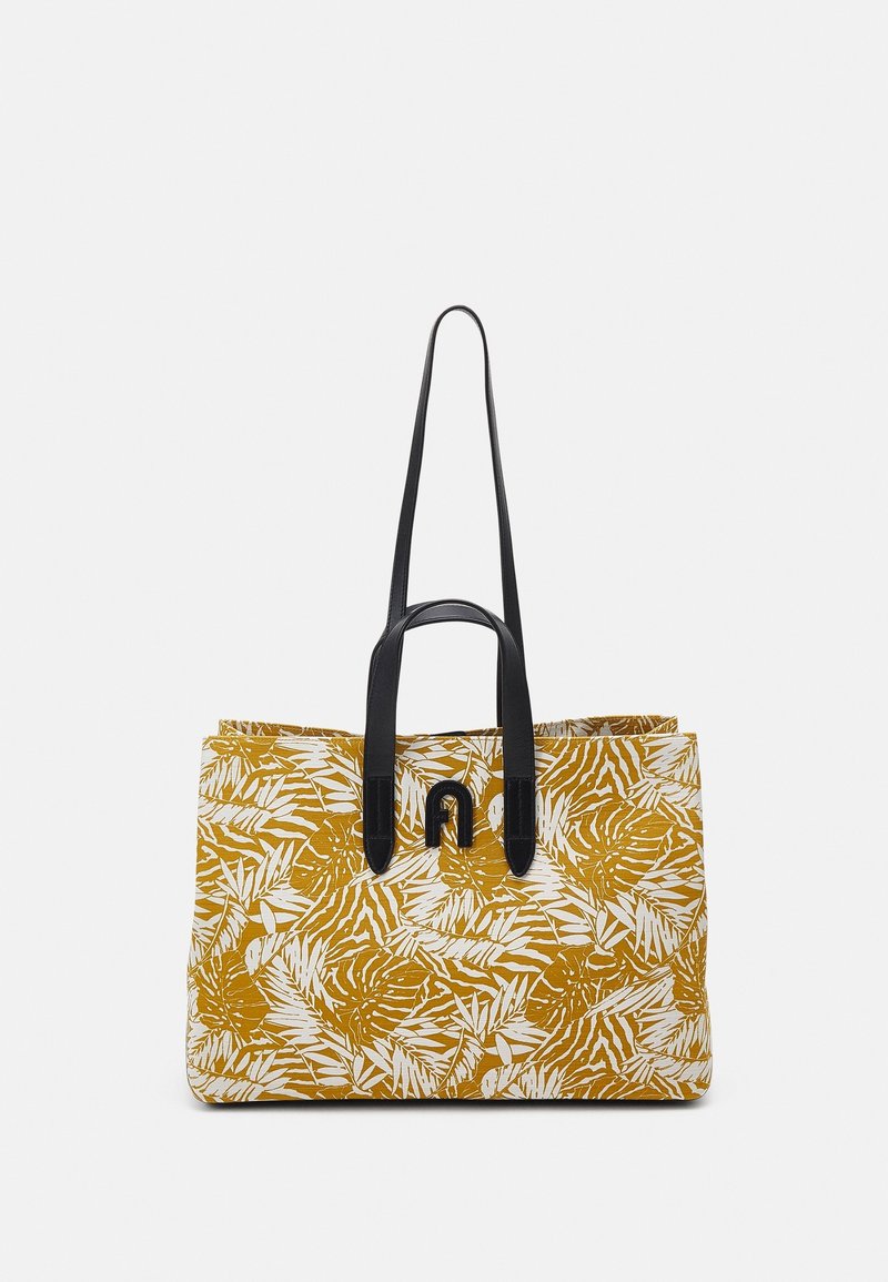 Tote bag with a mustard yellow base and white tropical leaf pattern. Features two black leather handles and a black logo detail.