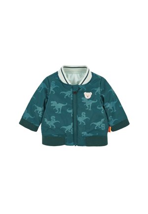 Teal toddler jacket with all-over dinosaur print, ribbed cuffs and collar, front zipper, and small teddy bear patch on chest.