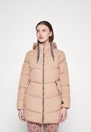 Pufferjack in lichtbeige met een capuchon, ritsluiting en grijze accenten. Beschikt over gestikte vulling en zijzakken.