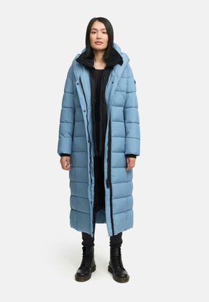Light blue long puffer coat with horizontal quilted pattern, zip closure, and hood. Worn over black clothing and complemented by black boots.