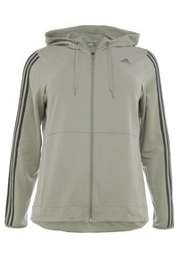 Sweat à capuche zippé vert clair avec bandes latérales grises, capuche à cordon de serrage, et un logo sur le côté supérieur gauche. Tissu doux, coupe décontractée, et manches longues.