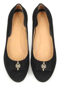 Black suede ballet flats with a rounded toe, a small black bow, and a gold logo accent. Soft insole with perforated pattern for breathability.