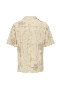 Beige Hemd mit kurzen Ärmeln aus strukturiertem Stoff, das braune Blumen- und abstrakte Muster sowie verschiedene Formen und Details aufweist.