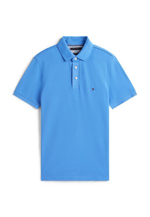 Blue polo shirt made of cotton with a collar, three-button placket, short sleeves, and a small contrasting logo near the hem.