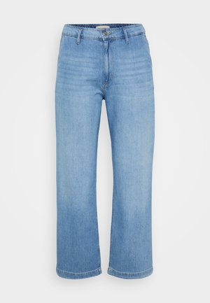 Jean en denim bleu clair, coupe large avec taille haute, fermeture à boutons et design à cinq poches. Présente une texture lisse et des jambes droites.
